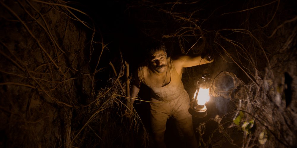 Tumbbad - Soham Shah holding the lantern. 