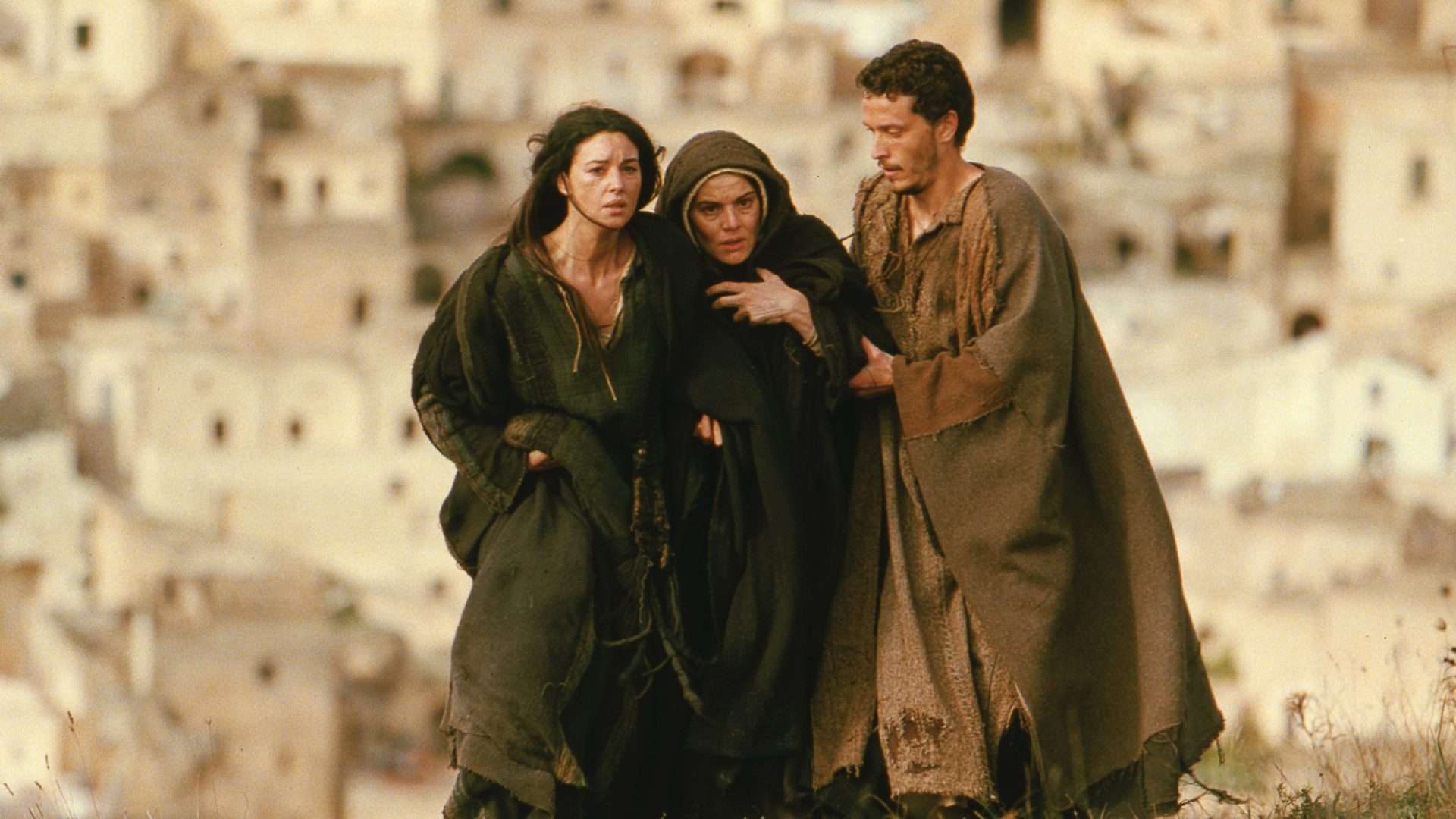 Monica Bellucci as Mary Magdalene, Maia Morgenstern as Mary & Christo Jivkov as Apostle John in The Passion of the Christ (2004). 