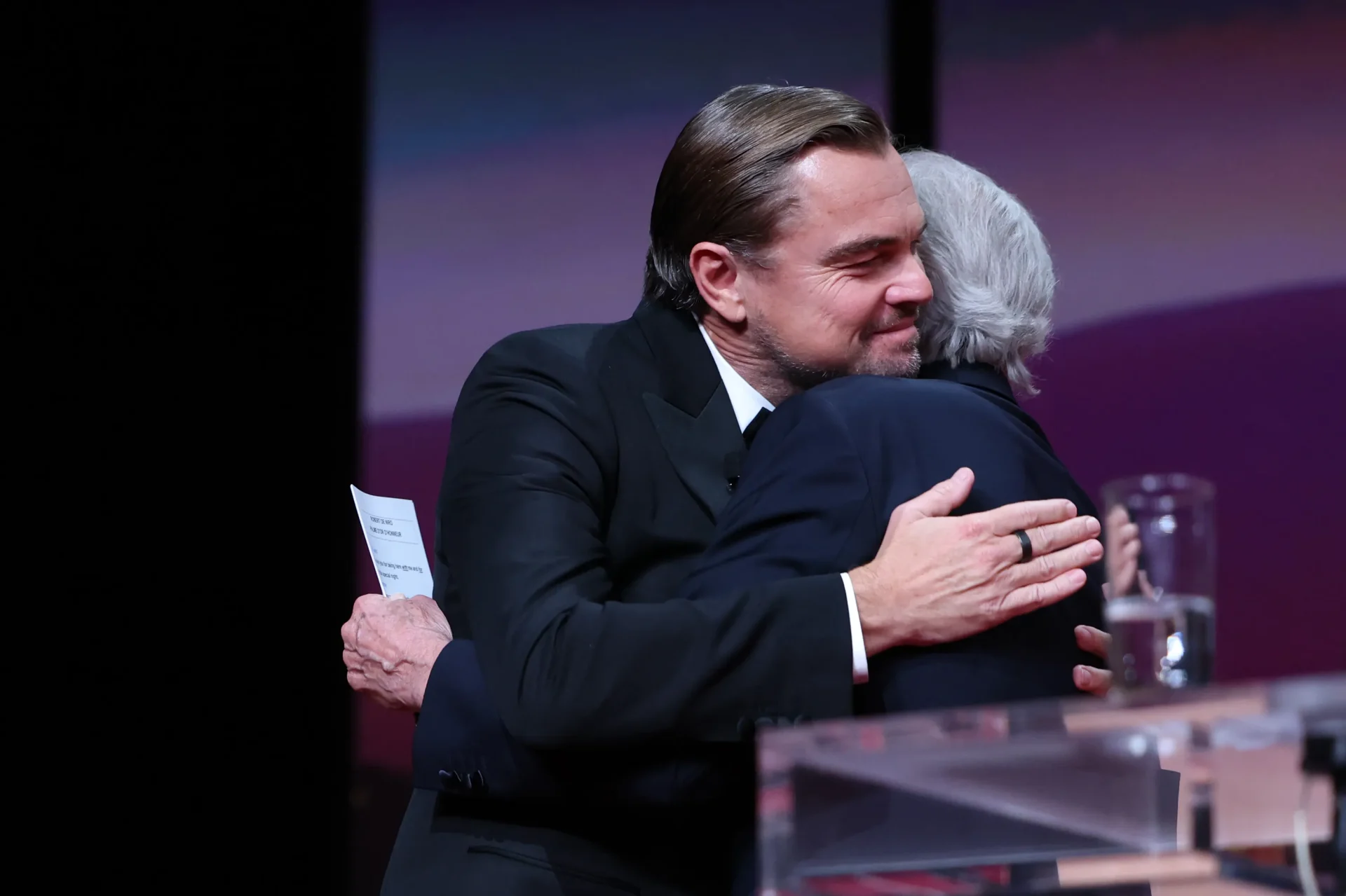 De Niro accepts the honorary Palme d’Or from DiCaprio.