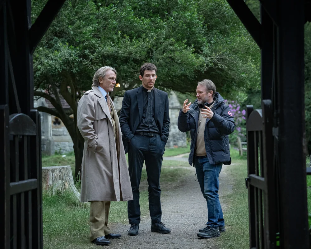 Wake Up Dead Man: A Knives Out Mystery. (L-R) Daniel Craig, Josh O’Connor and writer/director Rian Johnson on the set of Wake Up Dead Man: A Knives Out Mystery. Cr. John Wilson/Netflix © 2025