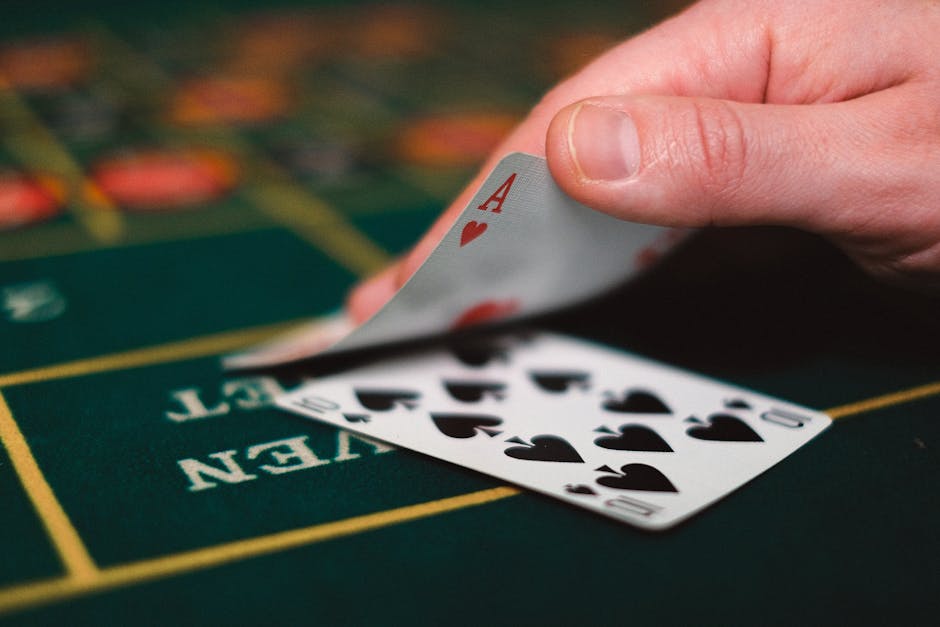 Hand dealing cards on blackjack table